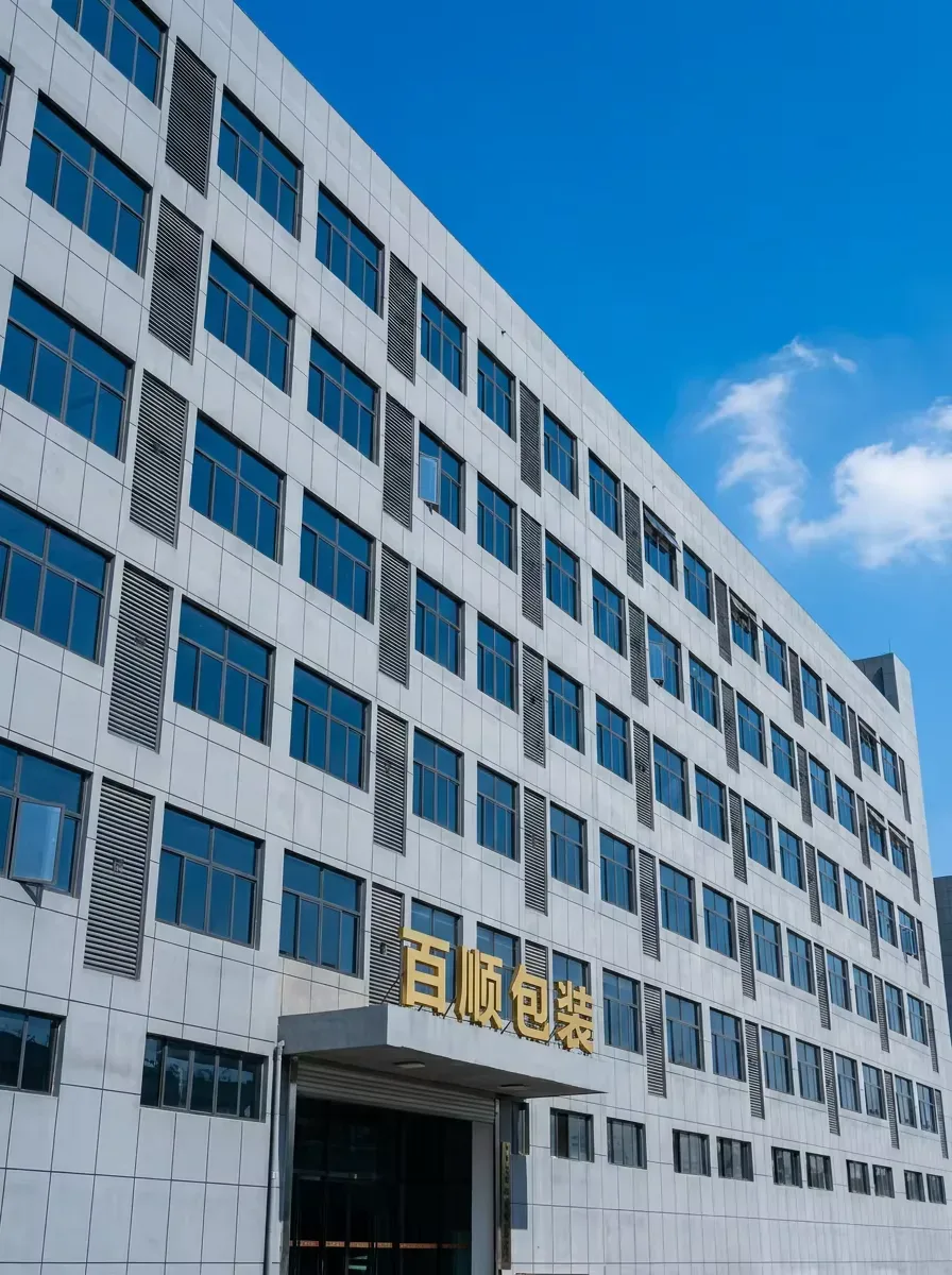 Exterior of the Baishun Pack factory building in Shenzhen with the company signage on the facade