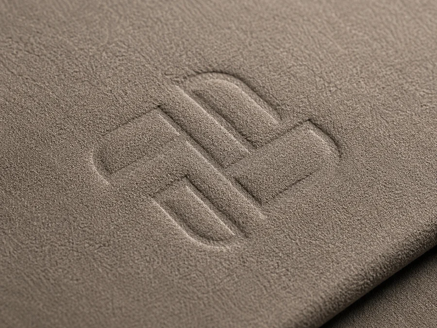 Blind-debossed mark on taupe microfiber suede